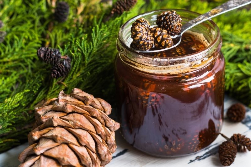 a-jar-of-homemade-jam-made-of-pine-cones-on-a-dark-background